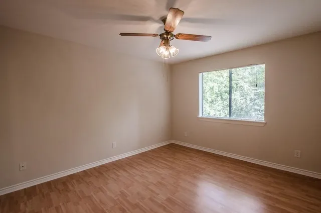 wooden floor in an empty room with a window