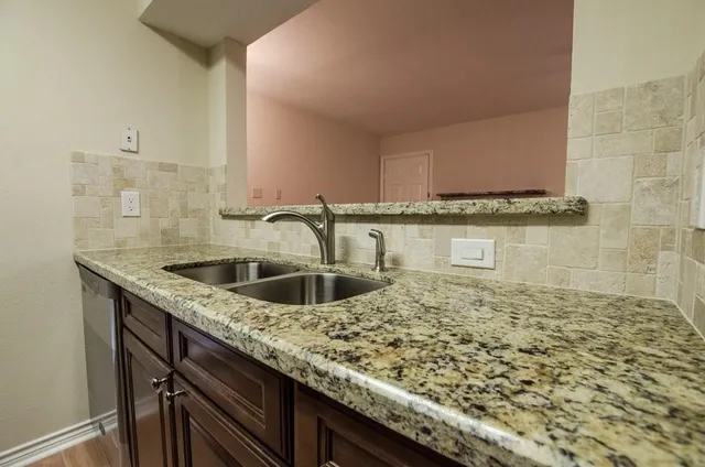 a kitchen with a sink and cabinets