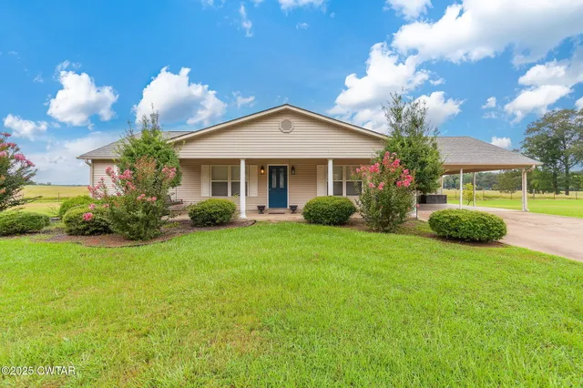 a view of a house with a yard and garden