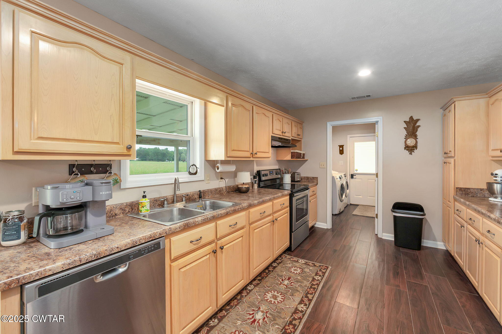 114 Falcon Cove Middleton, TN 38052 - Photo 5 of 24 a kitchen with stainless steel appliances granite countertop a stove a sink dishwasher a refrigerator and cabinets with wooden floor