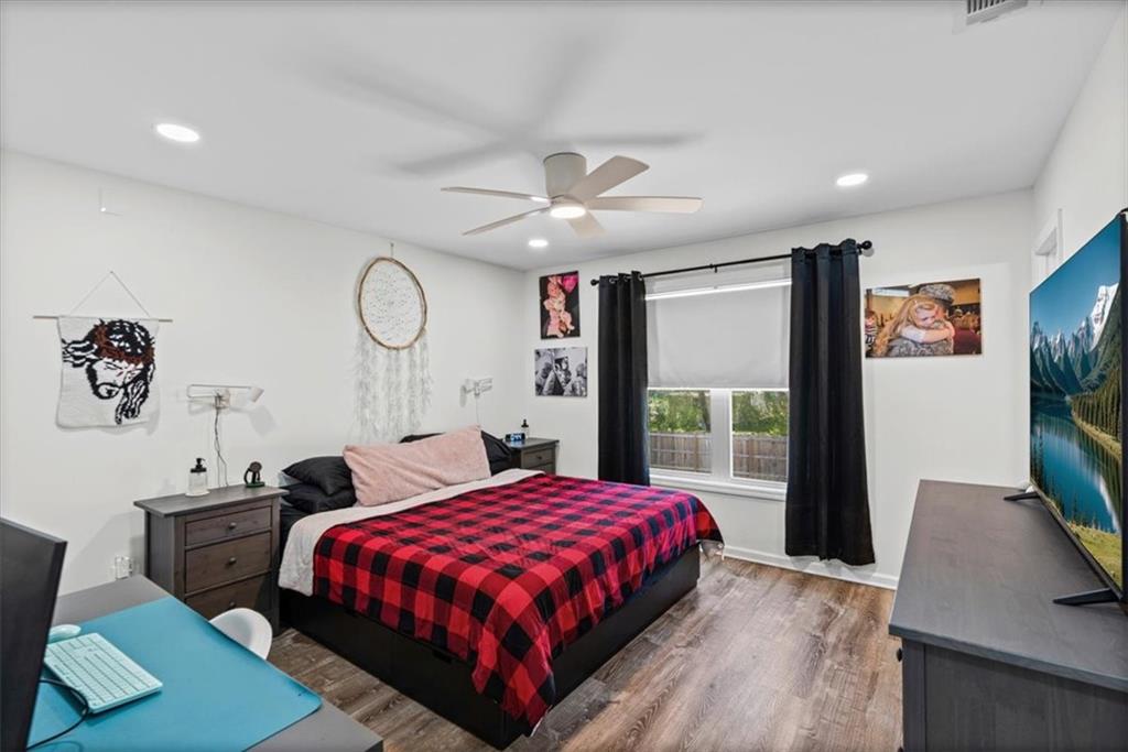 62 Dude Street Northwest Rome, GA 30165 - Photo 11 of 21 a bedroom with a bed a dresser with wooden floor