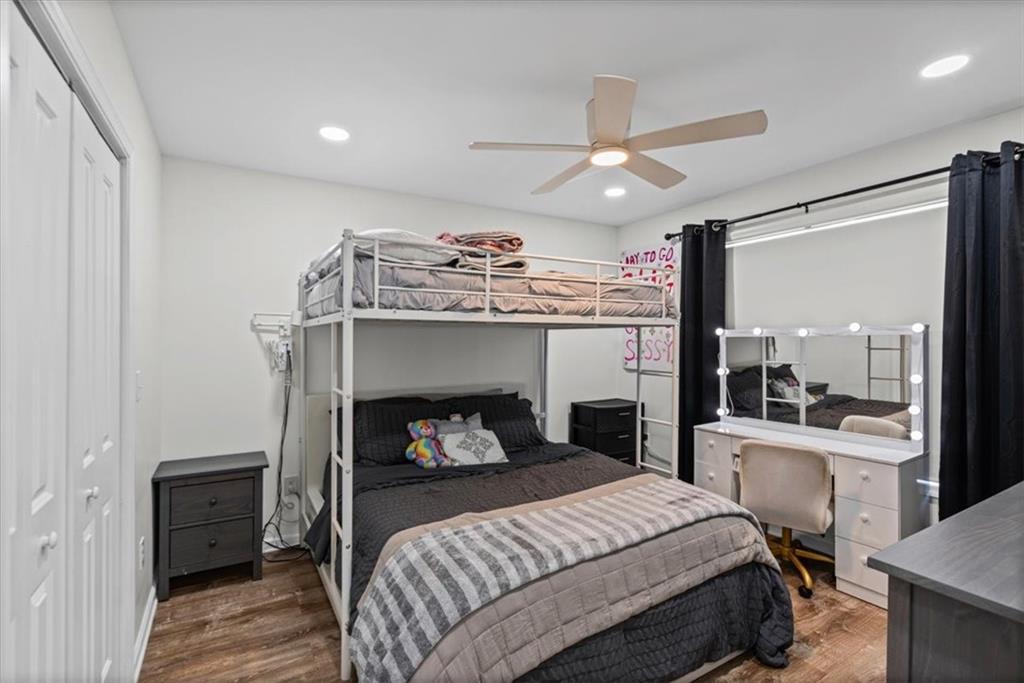 62 Dude Street Northwest Rome, GA 30165 - Photo 15 of 21 a bedroom with a bed and a large mirror with a bookshelf