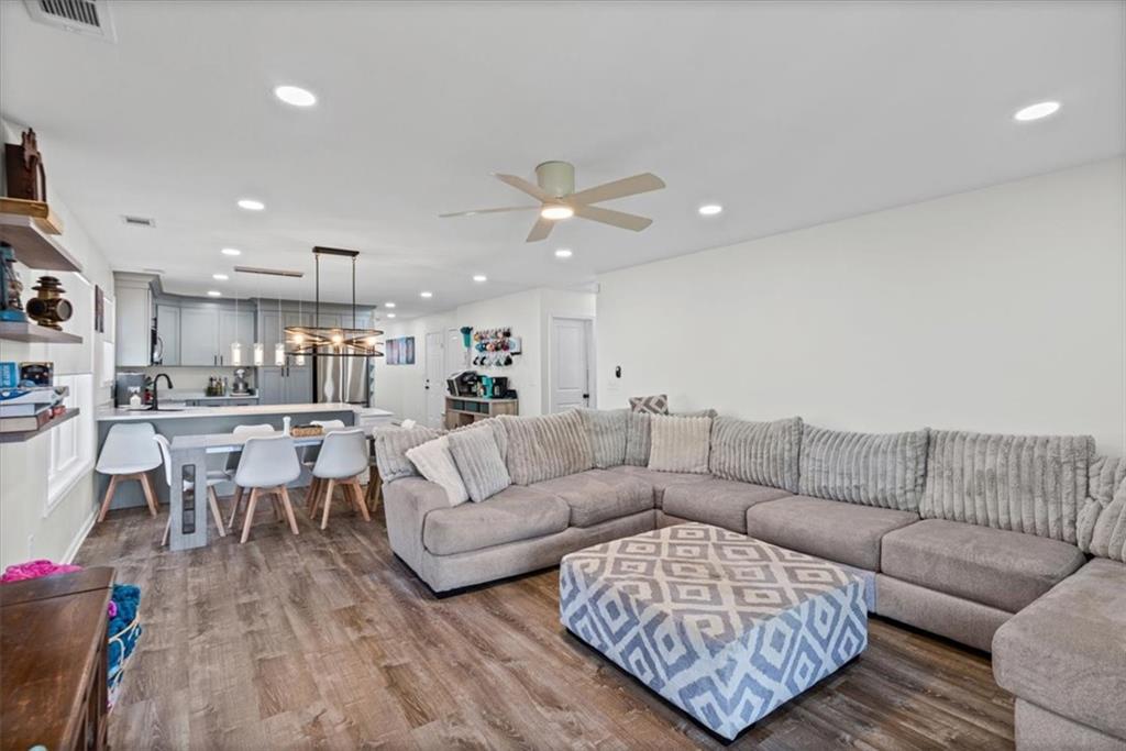 62 Dude Street Northwest Rome, GA 30165 - Photo 4 of 21 a living room with furniture kitchen view and a chandelier
