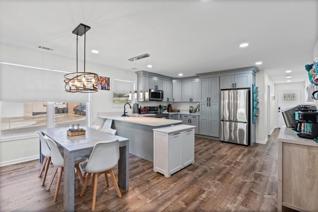62 Dude Street Northwest Rome, GA 30165 - Photo 8 of 21 a view of kitchen with sink refrigerator dining table and chairs