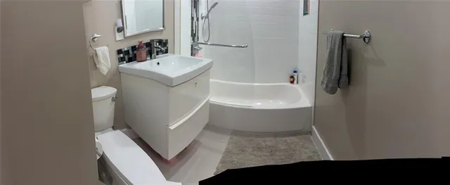 a bathroom with a sink a toilet and a bathtub
