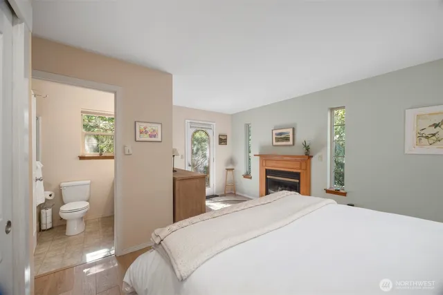 a bedroom with a bed and a view of bathroom