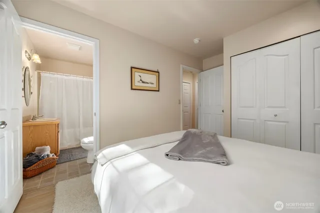 a bedroom with a bed and a view of bathroom