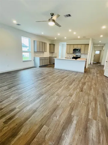 a view of kitchen and empty room