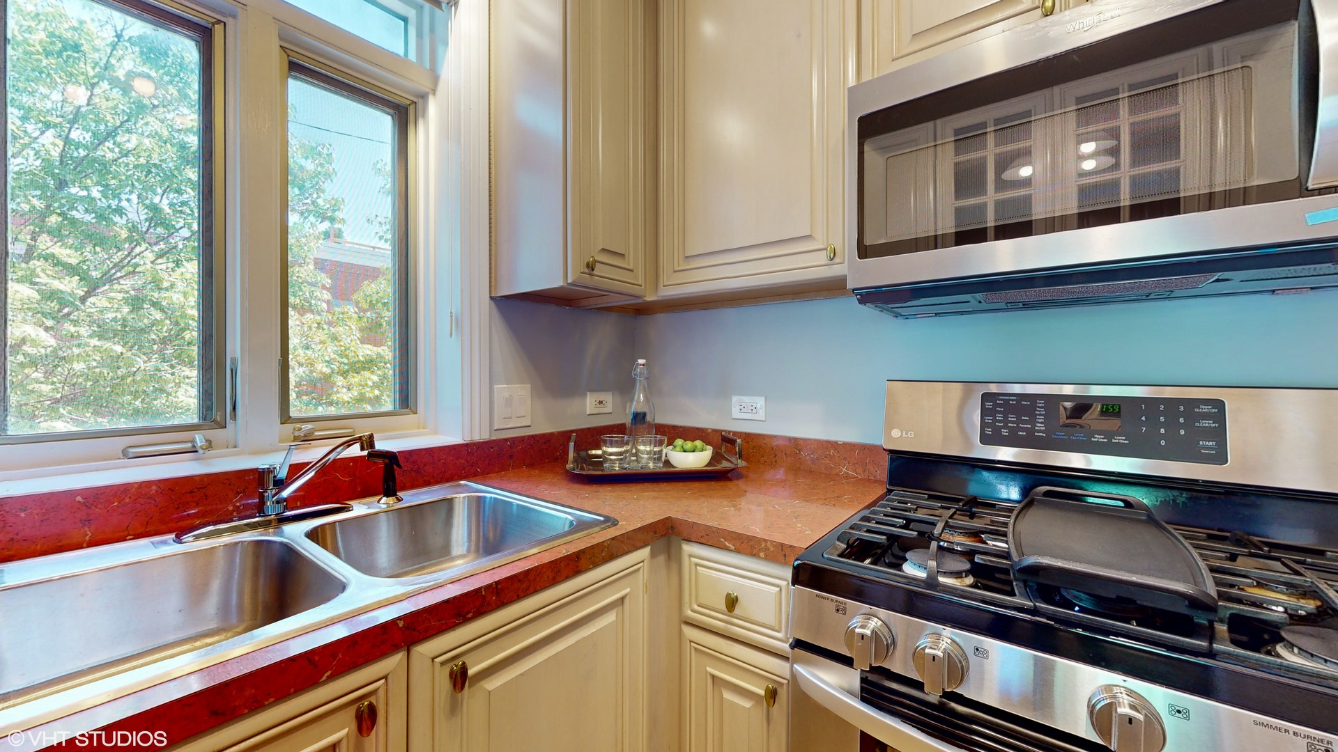 1401 West Fillmore Street, Unit 2 Chicago, IL 60607 - Photo 11 of 26 a kitchen with stainless steel appliances granite countertop a sink stove and cabinets