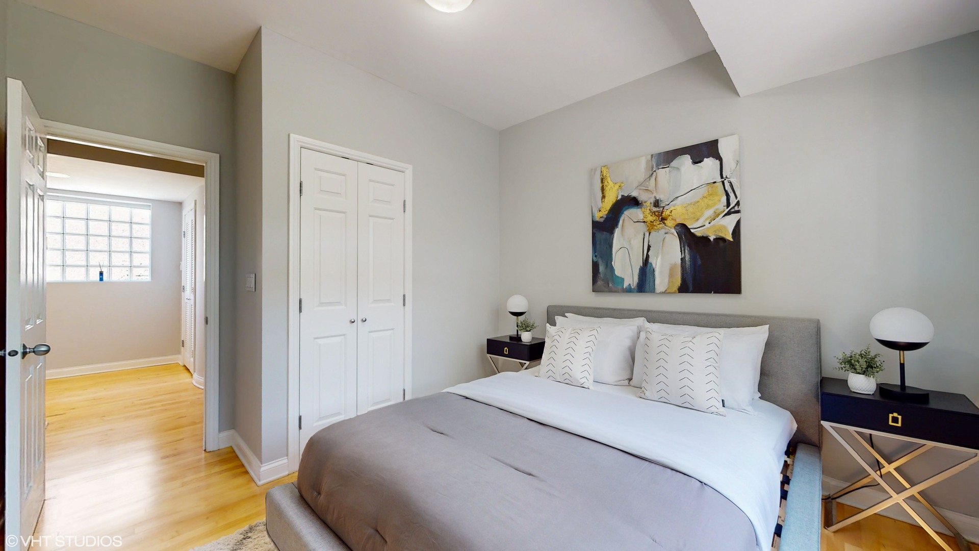 1401 West Fillmore Street, Unit 2 Chicago, IL 60607 - Photo 14 of 26 a bedroom with a bed and a painting on the wall