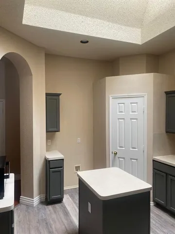 a kitchen with a refrigerator and a stove