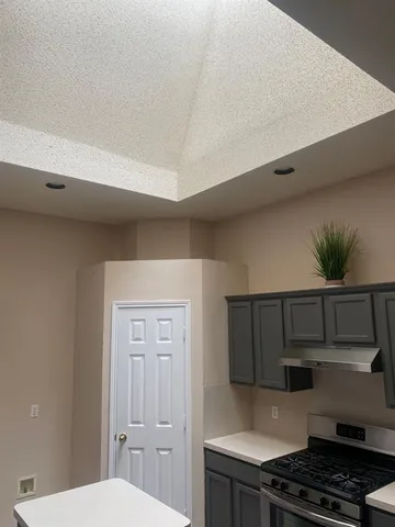 a kitchen that has a sink and a stove