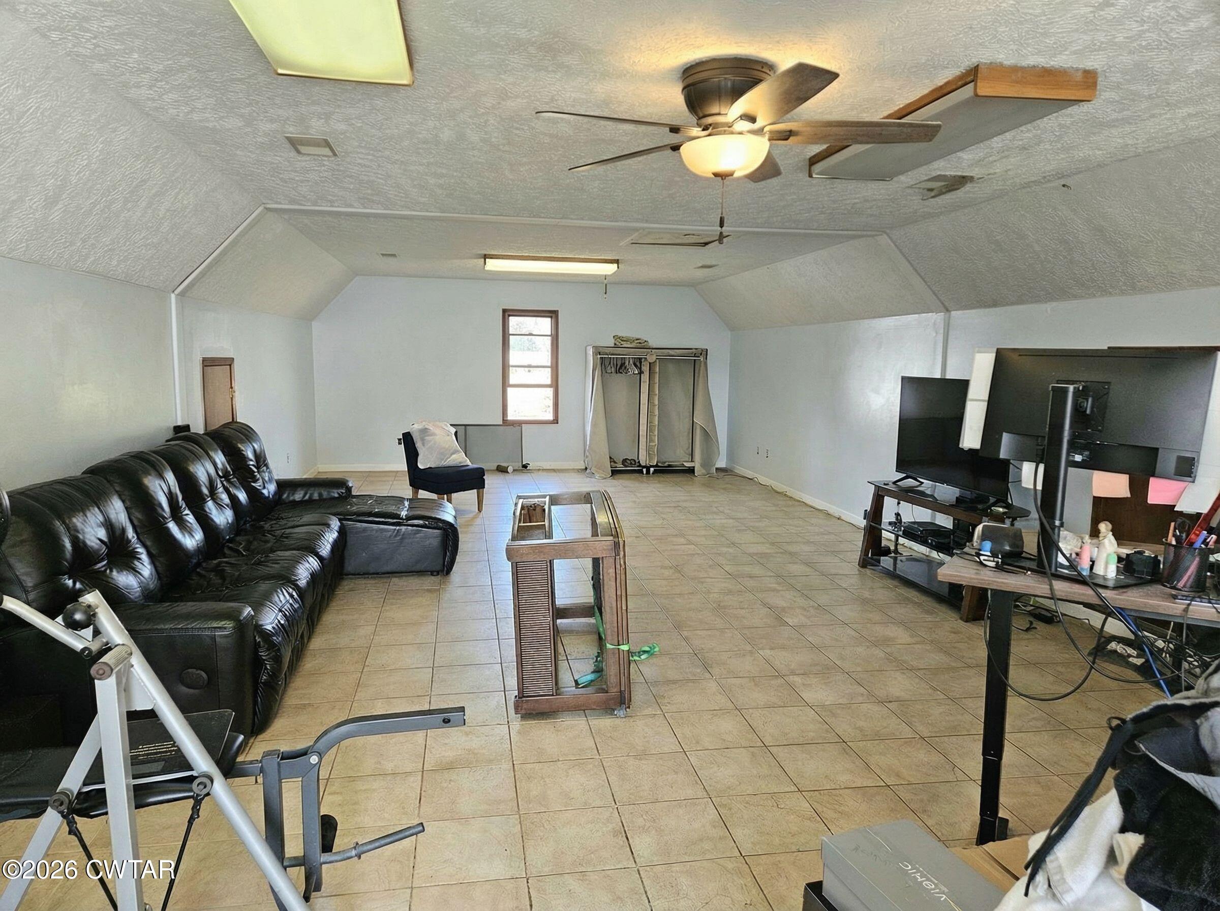 103 Spring Creek Law Road Jackson, TN 38305 - Photo 12 of 35 a living room with furniture a chandelier and a black rug