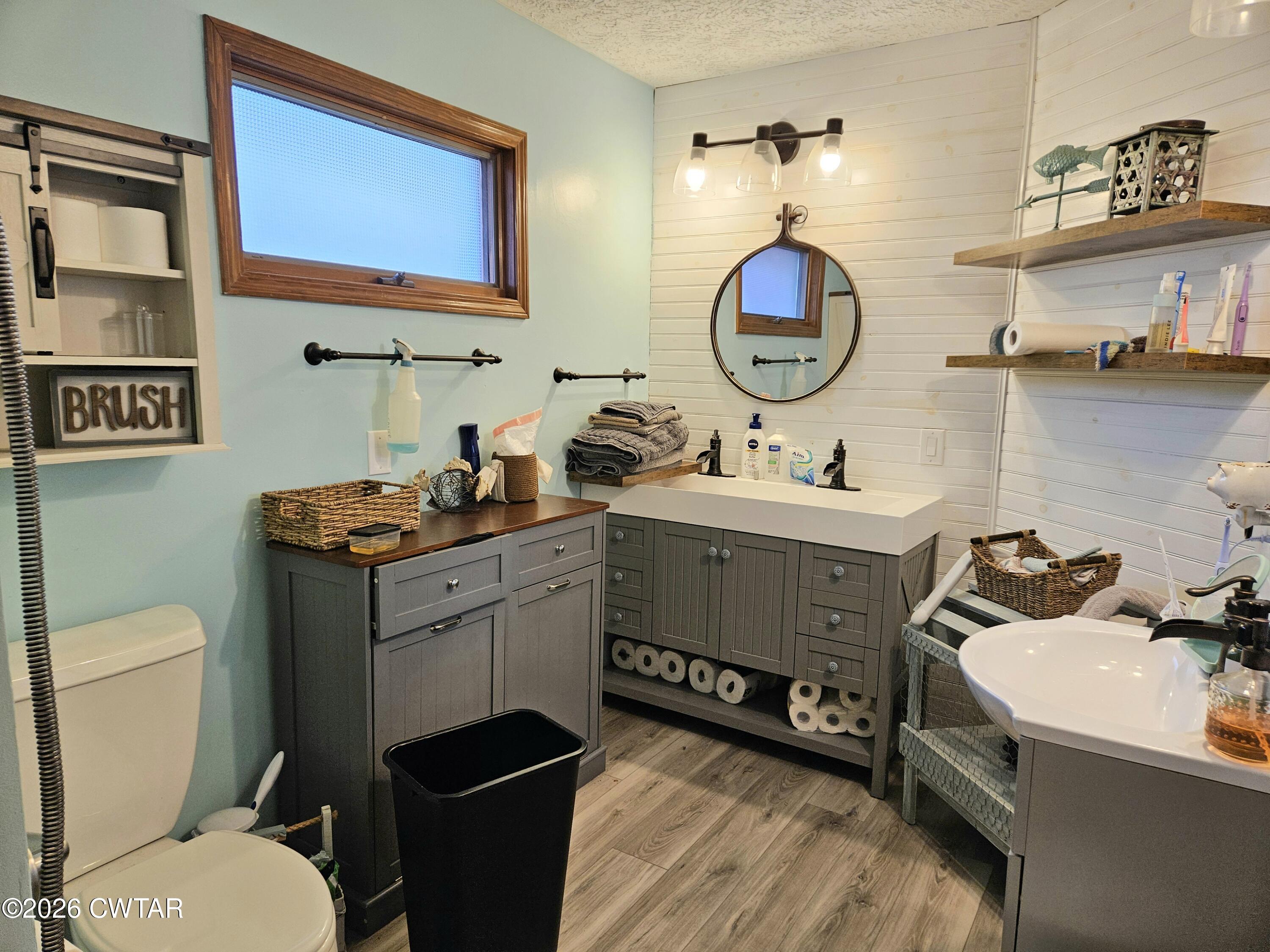 103 Spring Creek Law Road Jackson, TN 38305 - Photo 15 of 35 a bathroom with a toilet a sink and a mirror