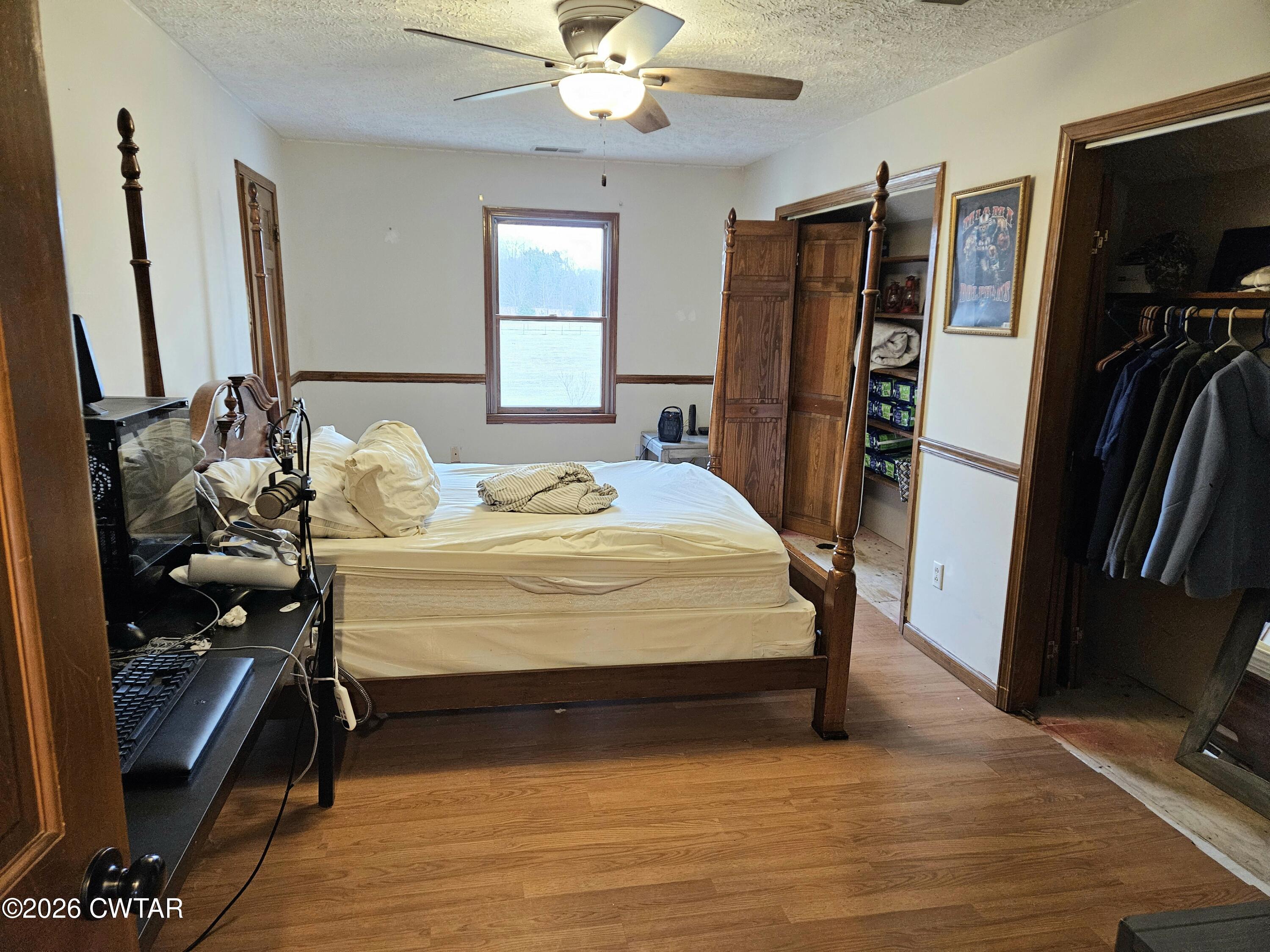 103 Spring Creek Law Road Jackson, TN 38305 - Photo 18 of 35 a bedroom with a bed and a flat tv screen on the dresser