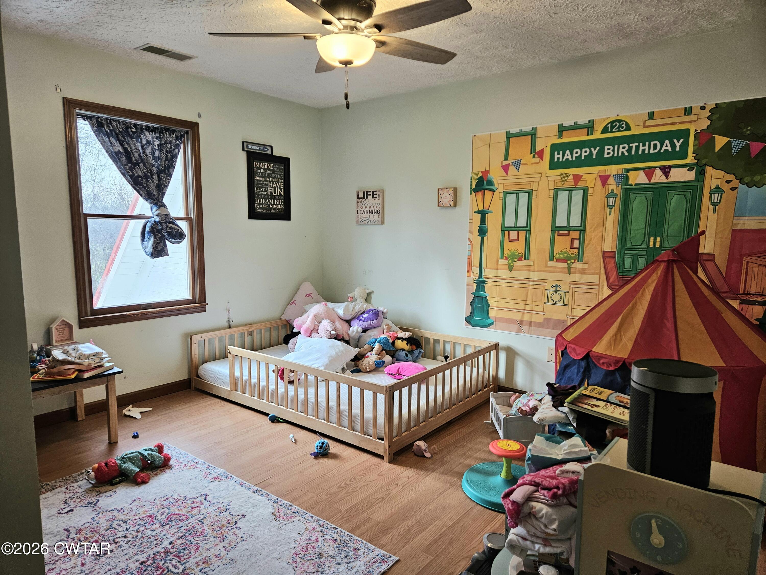 103 Spring Creek Law Road Jackson, TN 38305 - Photo 20 of 35 a bedroom with furniture and a window