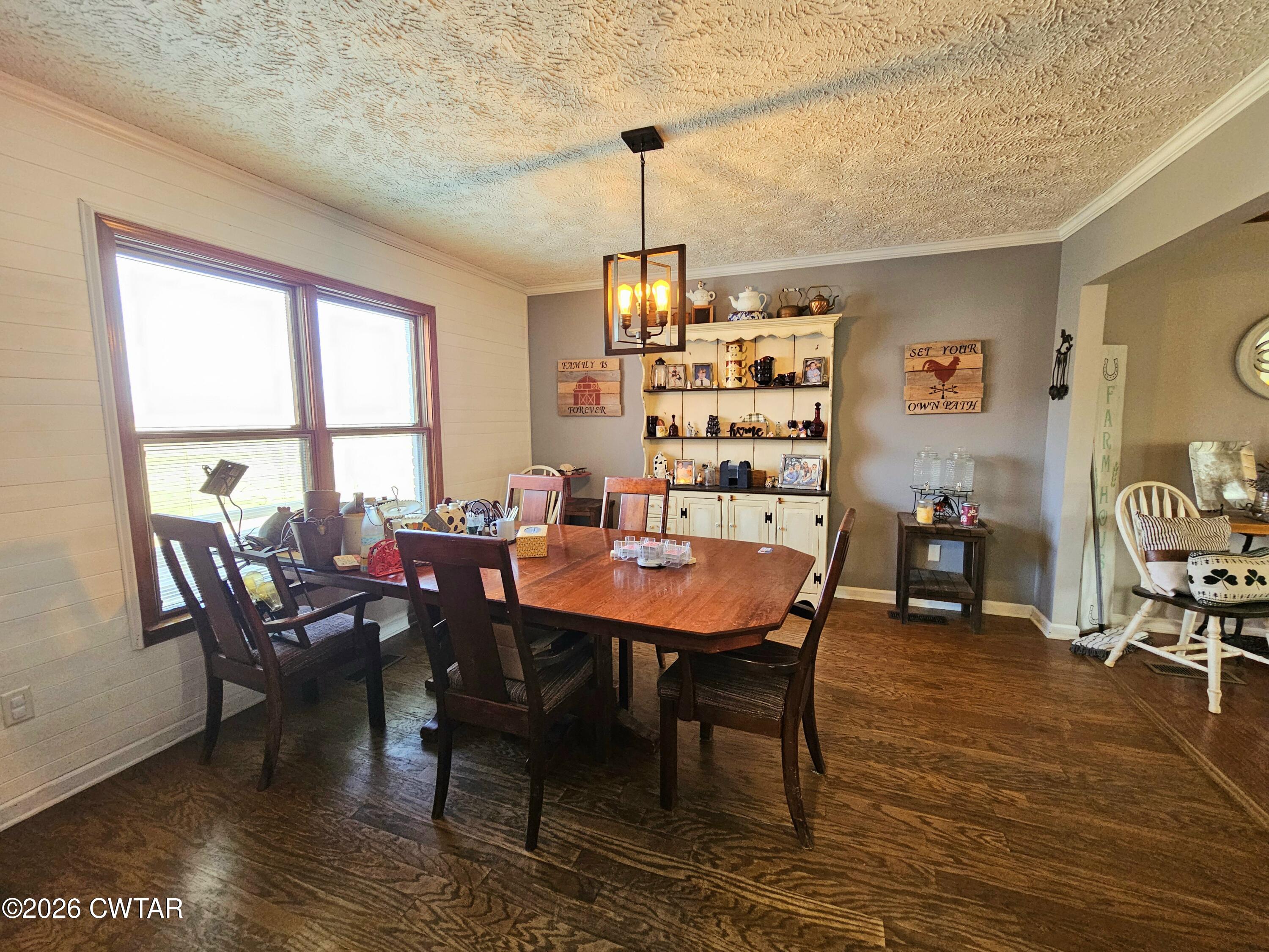 103 Spring Creek Law Road Jackson, TN 38305 - Photo 8 of 35 a dining room with furniture a chandelier and wooden floor