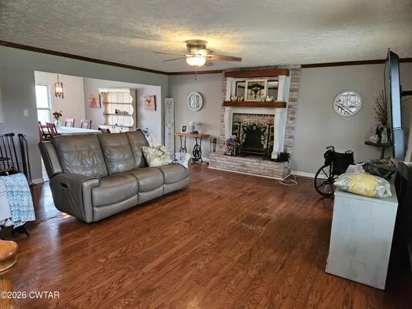 a living room with furniture a chandelier and a black rug