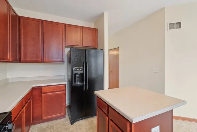 a kitchen with stainless steel appliances a refrigerator and cabinets