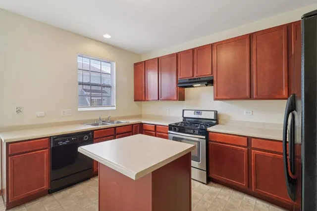a kitchen with a sink stove and cabinets