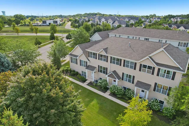 an aerial view of a house with a garden and lake view