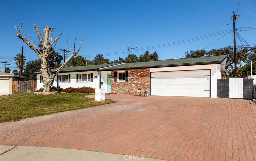 1309 Stillman Avenue Redlands, CA 92374 - Photo 1 of 23 a front view of a house with a garden and yard