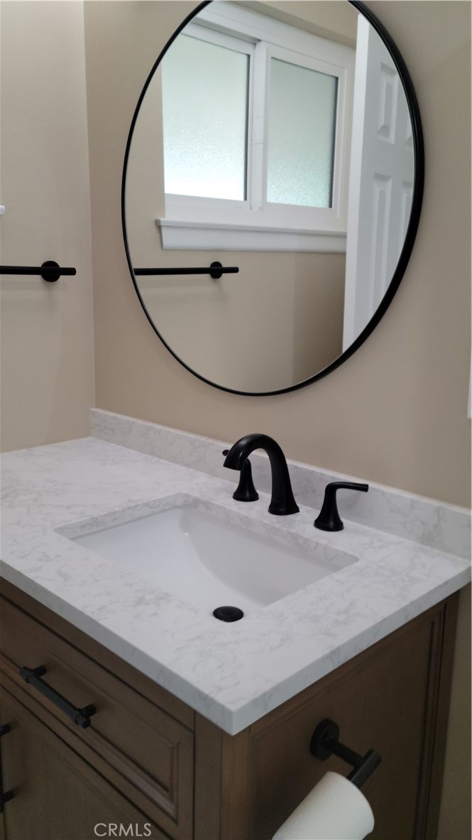 1309 Stillman Avenue Redlands, CA 92374 - Photo 11 of 23 a bathroom with a sink and mirror