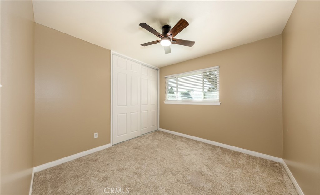 1309 Stillman Avenue Redlands, CA 92374 - Photo 14 of 23 an empty room with ceiling fan and windows