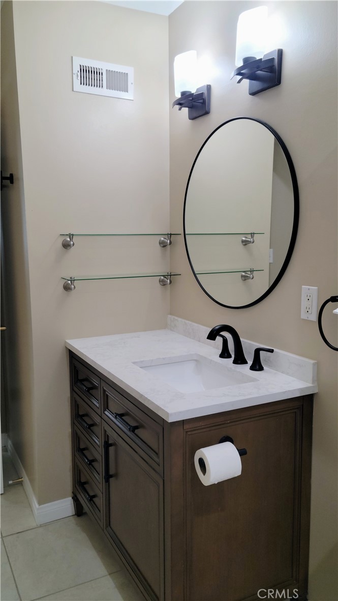 1309 Stillman Avenue Redlands, CA 92374 - Photo 16 of 23 a bathroom with a sink and a mirror