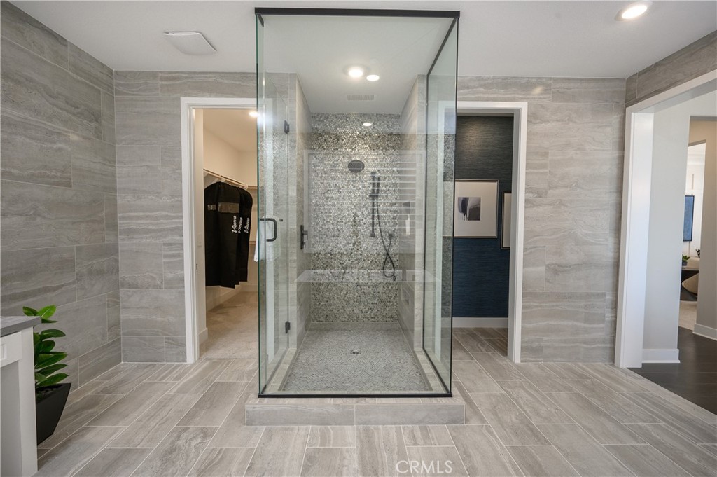 13093 Edgware Drive Rancho Cucamonga, CA 91739 - Photo 16 of 25 a bathroom with a shower and a mirror