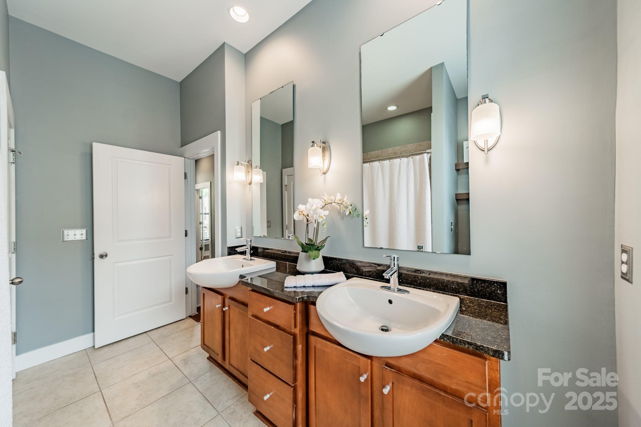 2988 Textile Way Charlotte, NC 28205 - Photo 19 of 36 a bathroom with a sink double vanity and a mirror
