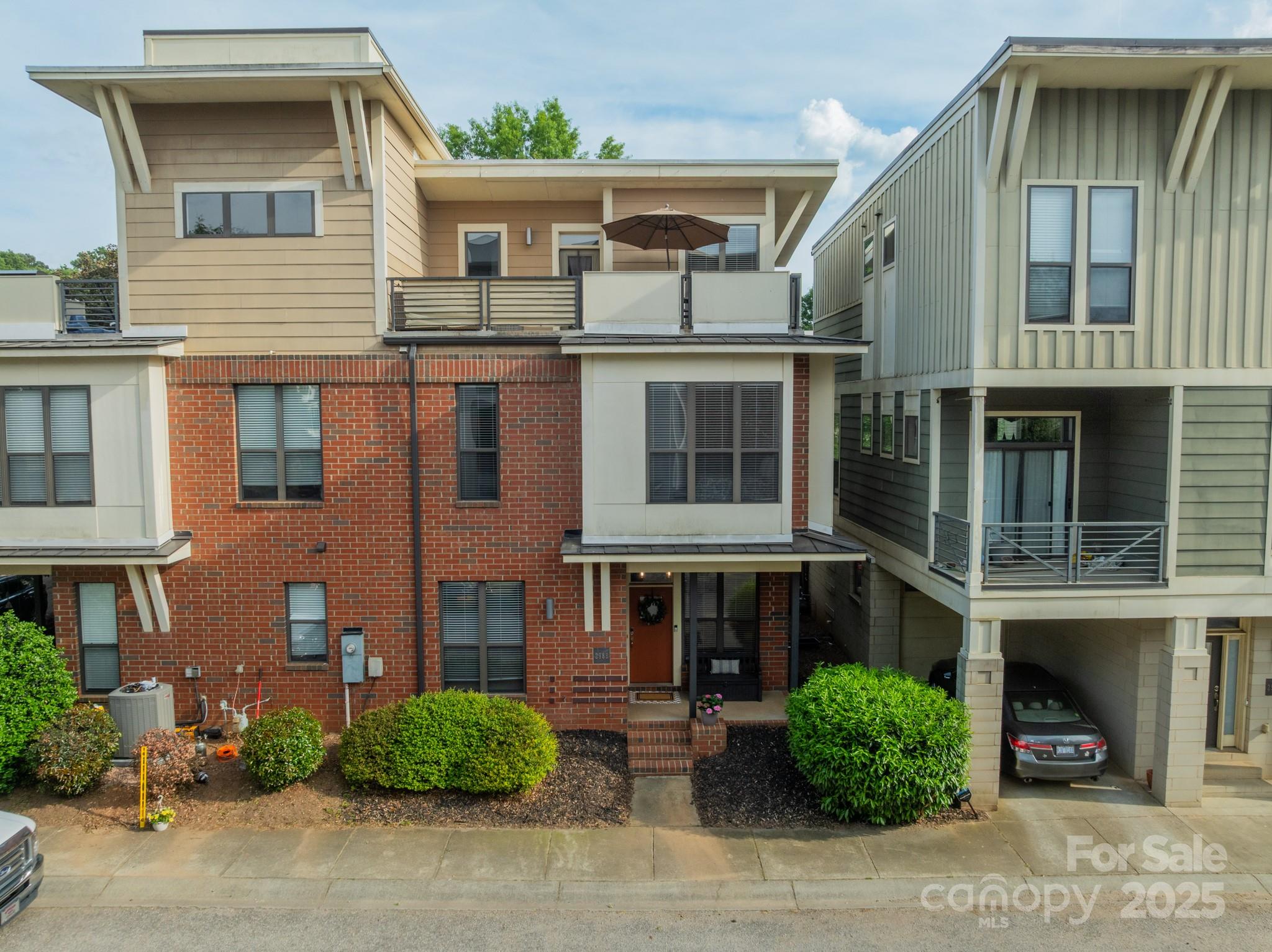 2988 Textile Way Charlotte, NC 28205 - Photo 2 of 36 a front view of a house with a yard and garage