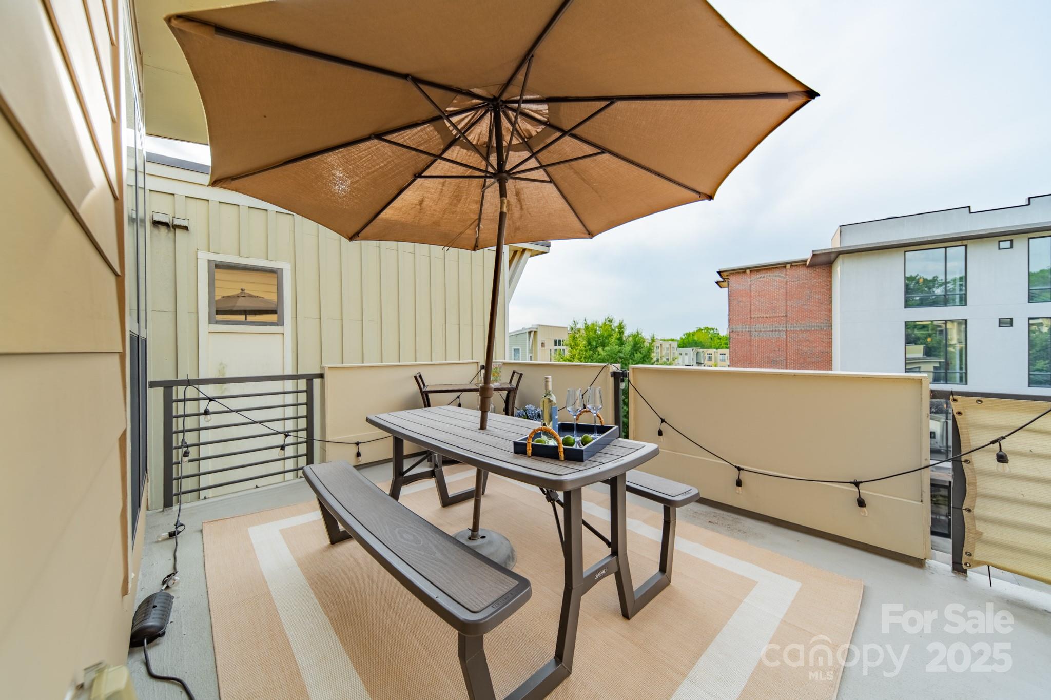 2988 Textile Way Charlotte, NC 28205 - Photo 28 of 36 a view of balcony with furniture and umbrella
