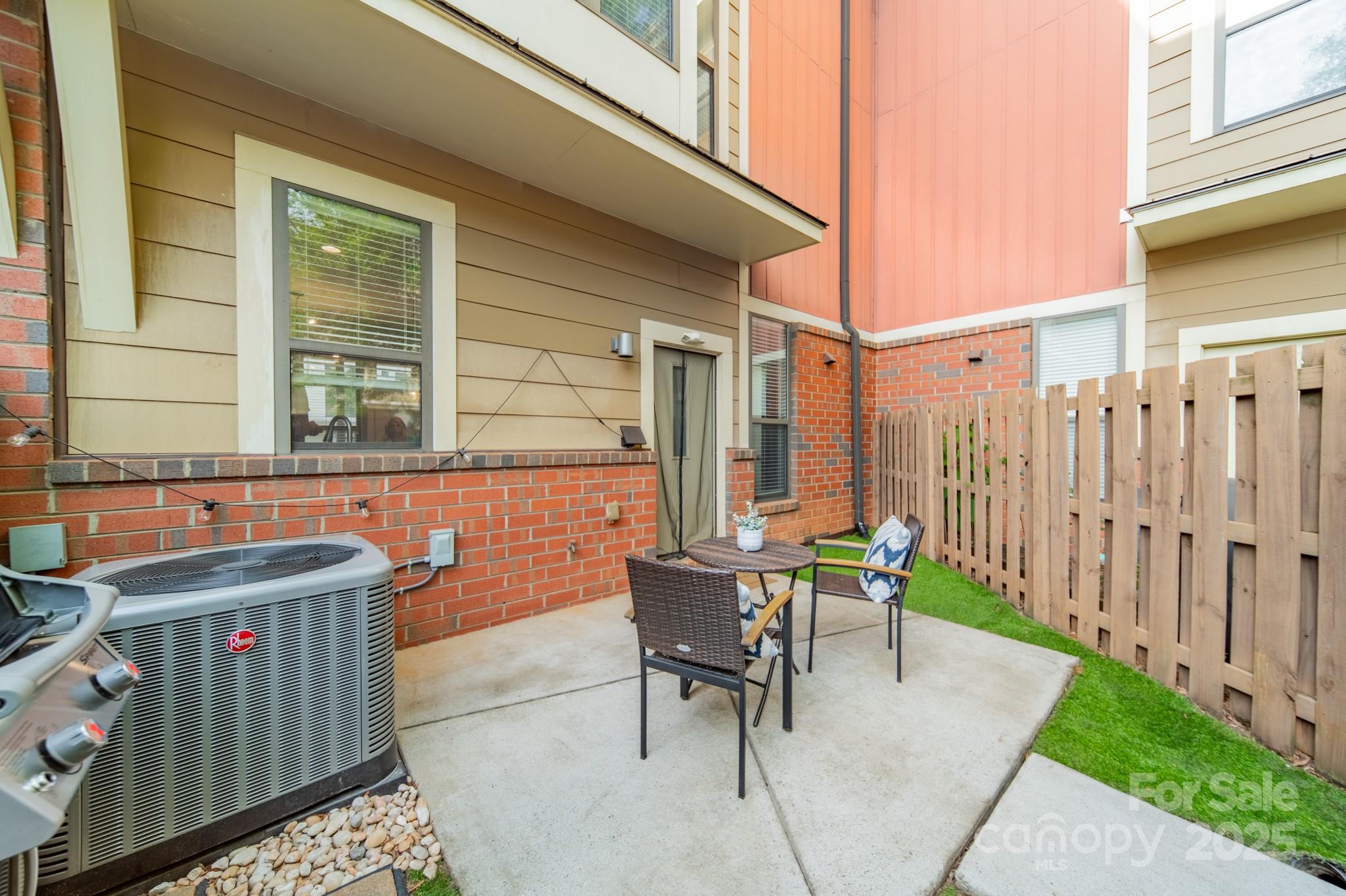 2988 Textile Way Charlotte, NC 28205 - Photo 30 of 36 a view of a patio with table and chairs and wooden fence