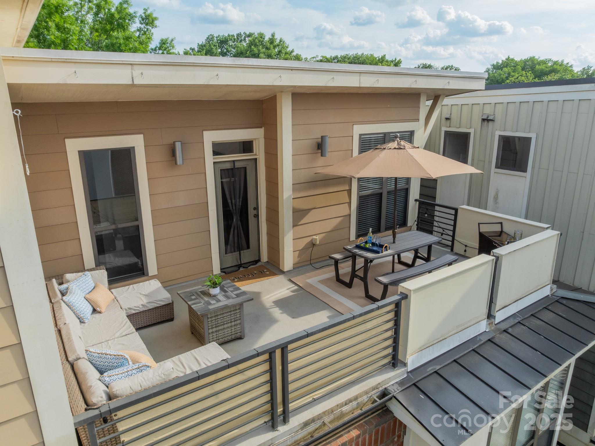 2988 Textile Way Charlotte, NC 28205 - Photo 32 of 36 a view of a patio with couches table and chairs with wooden floor