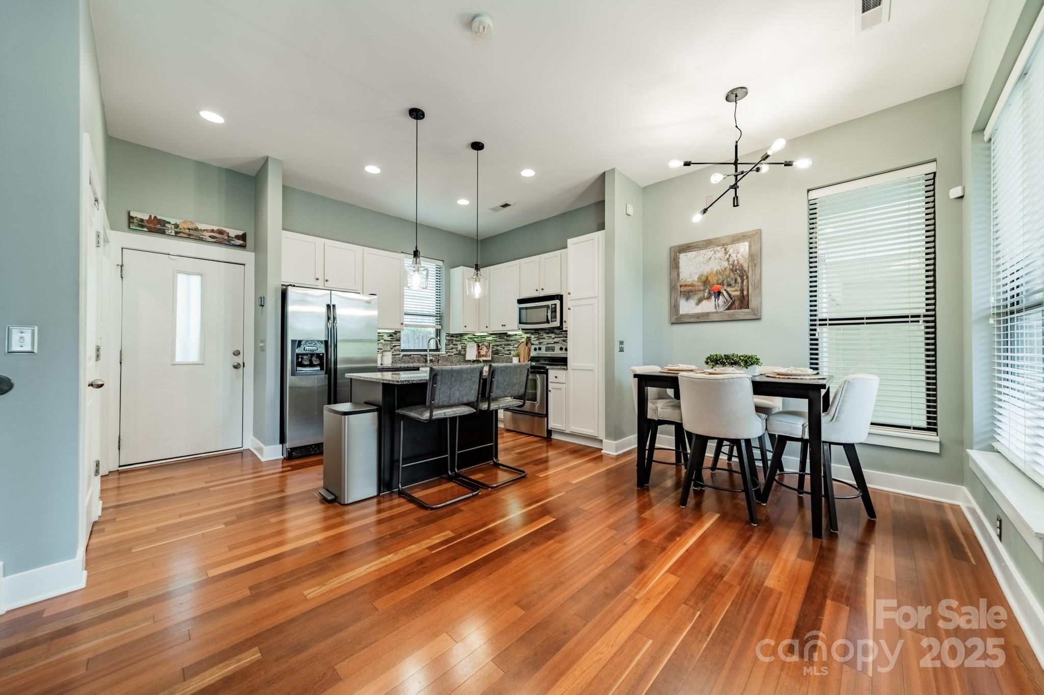 2988 Textile Way Charlotte, NC 28205 - Photo 4 of 36 a view of a dining room with furniture and wooden floor
