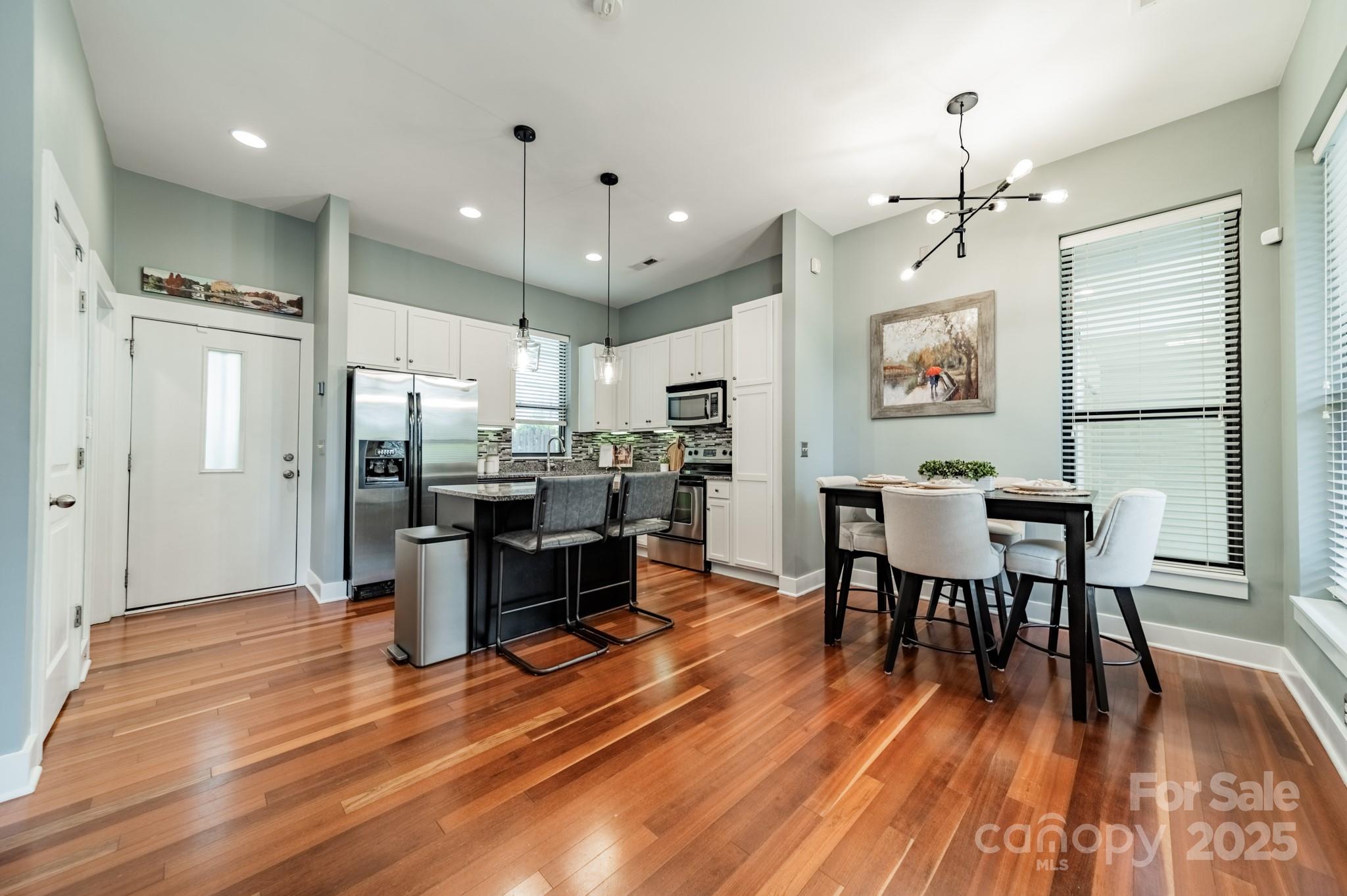 2988 Textile Way Charlotte, NC 28205 - Photo 8 of 36 a view of a dining room with furniture window and wooden floor