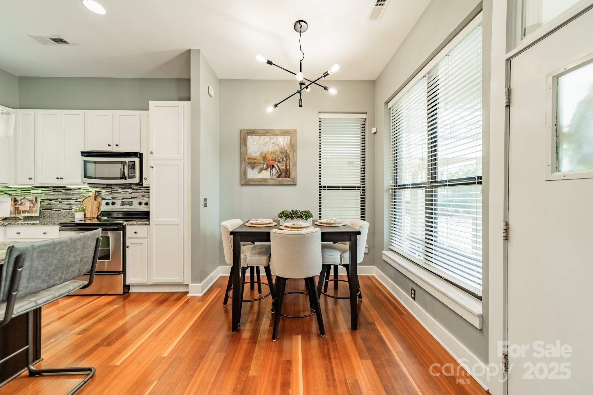 2988 Textile Way Charlotte, NC 28205 - Photo 10 of 36 a view of a dining room with furniture window and wooden floor