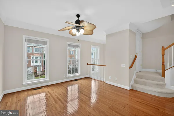 a view of an room with wooden floor and chandelier