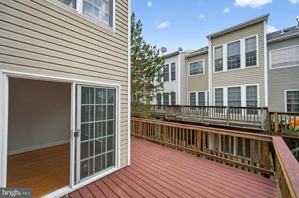 a view of balcony with wooden floor and fence and a window