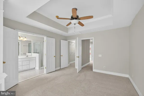 a view of an empty room and kitchen view