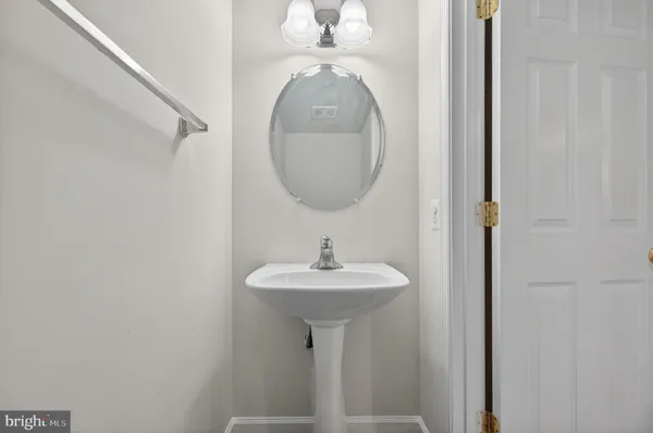 a bathroom with a sink a mirror and vanity