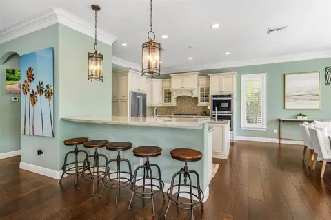 a kitchen with stainless steel appliances granite countertop a stove and a sink