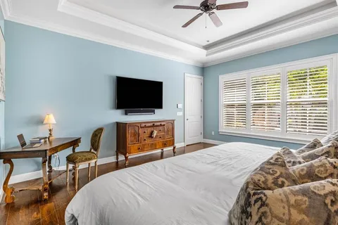 a bathroom with a granite countertop sink and a toilet