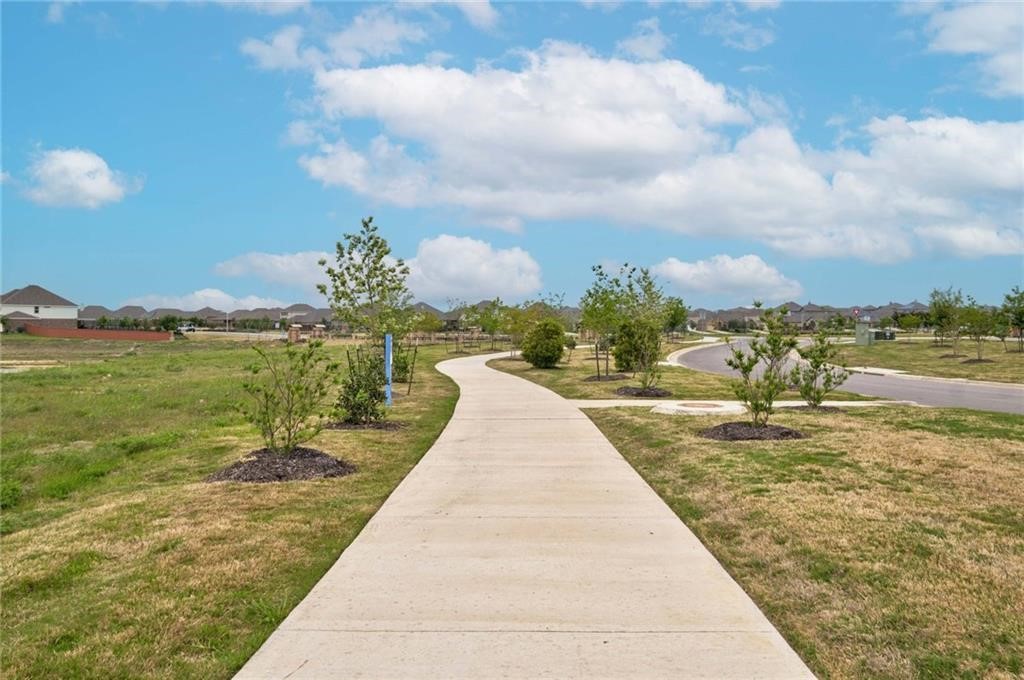 806 Pepperbark Loop Buda, TX 78610 - Photo 29 of 39 a view of a lake with a big yard