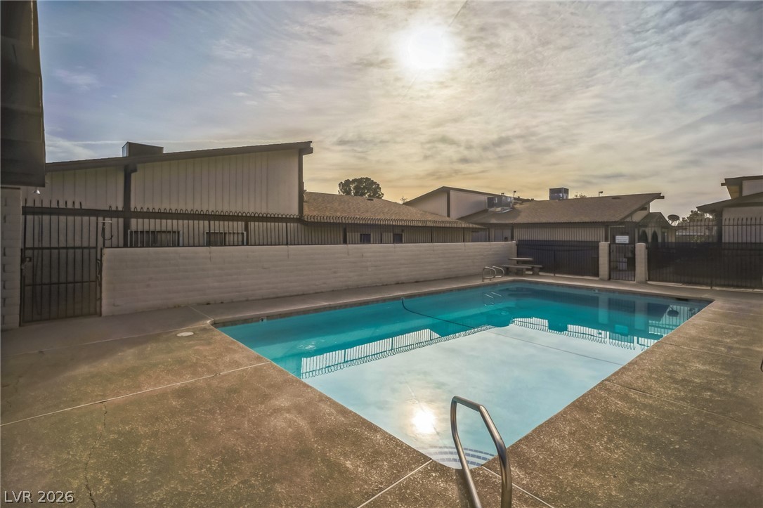 5733 Smoke Ranch Road, Unit D Las Vegas, NV 89108 - Photo 14 of 14 View of pool featuring patio surround