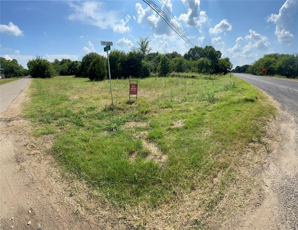 a view of outdoor space with green field and trees
