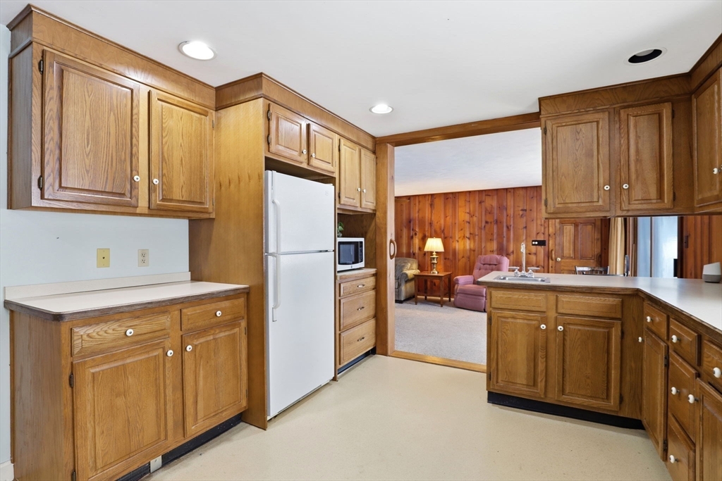 49 Jackson Road Scituate, MA 02066 - Photo 5 of 25 a kitchen with a sink refrigerator and cabinets
