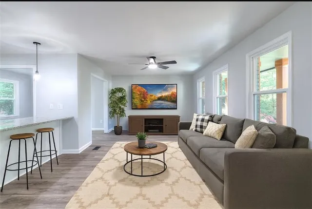 a living room with fireplace furniture and a large window