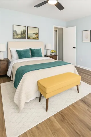 a bedroom with a bed and wooden floor